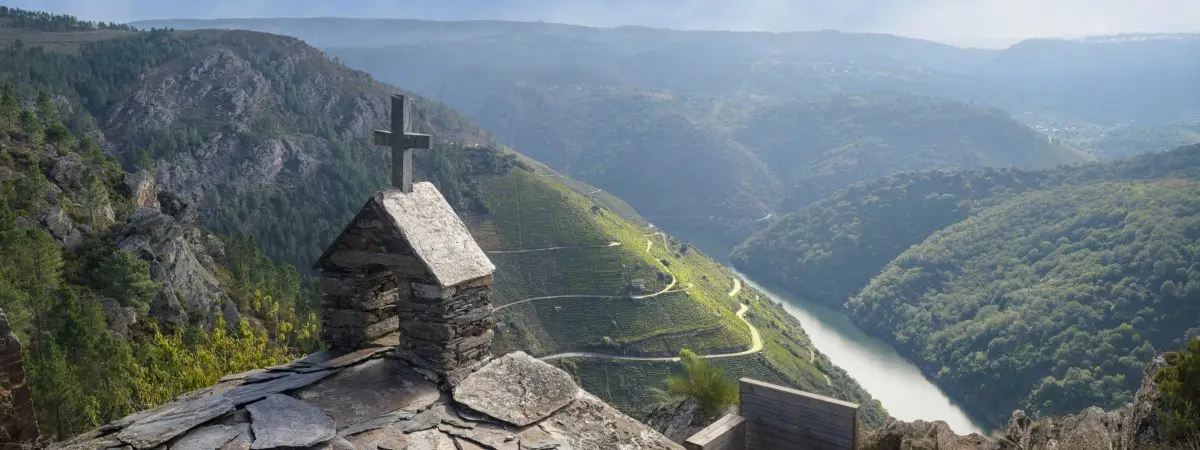 breathtaking view of the Ribeira Sacra from a small hermitage. The main focus is on the hermitage