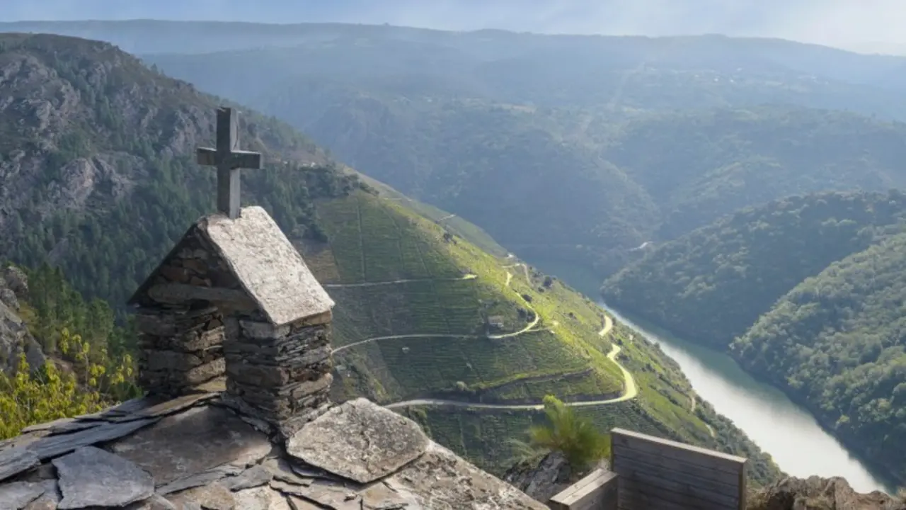 breathtaking view of the Ribeira Sacra from a small hermitage. The main focus is on the hermitage