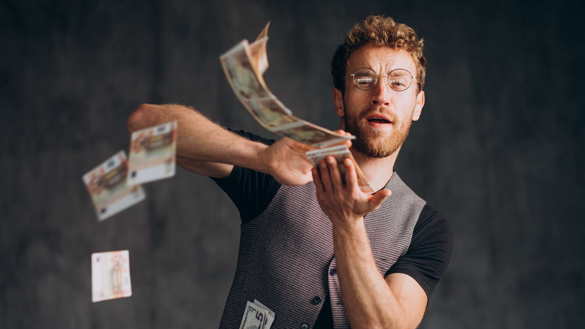 Man with banknotes isolated in studio